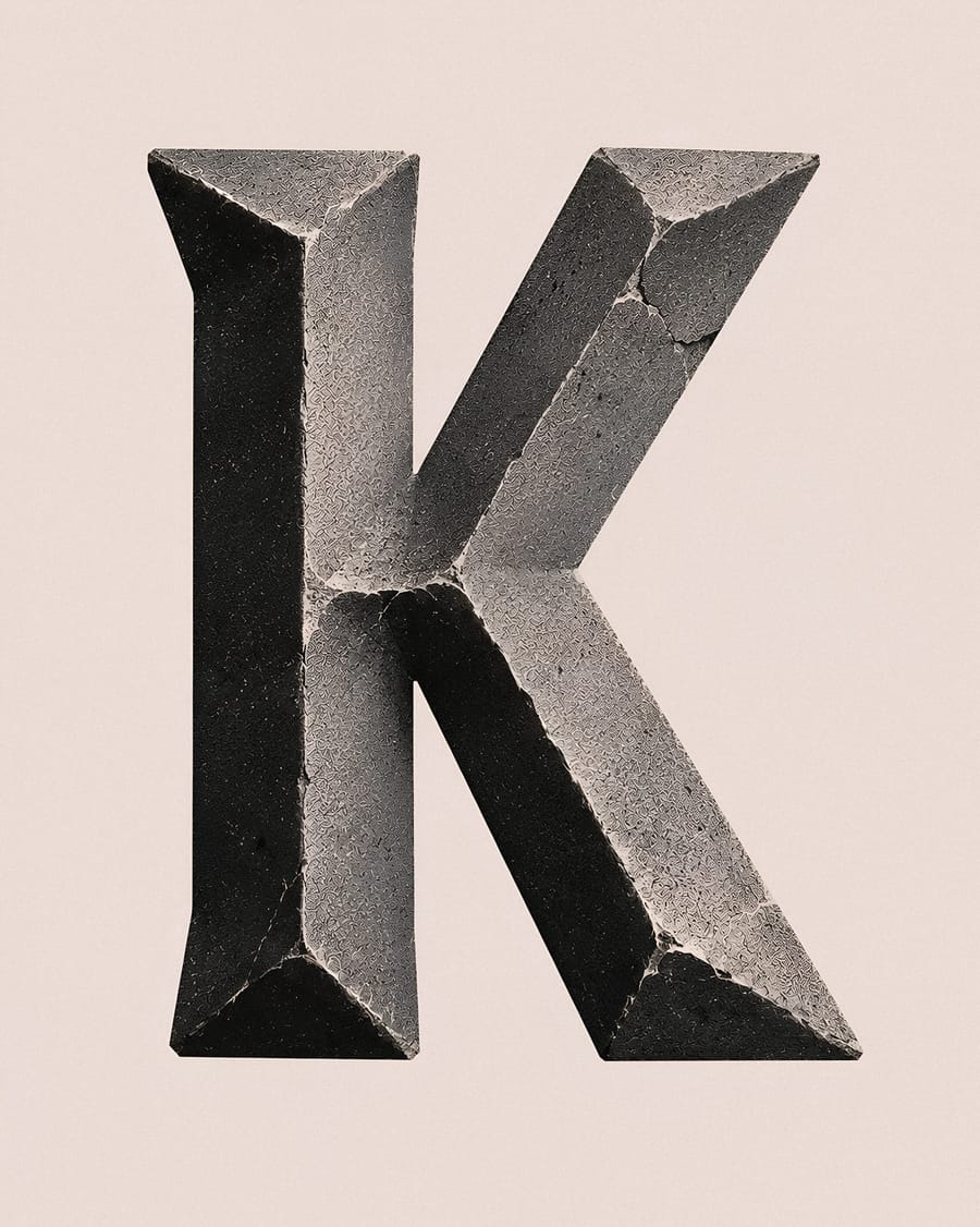 Stone Letter K Sculpture On Beige